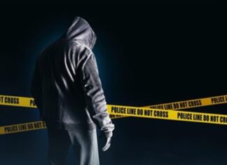 shadow figure with police tape in background