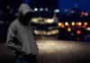 youth in hoodie night scene