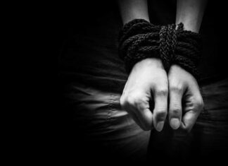 Human trafficking. Hands bound together,